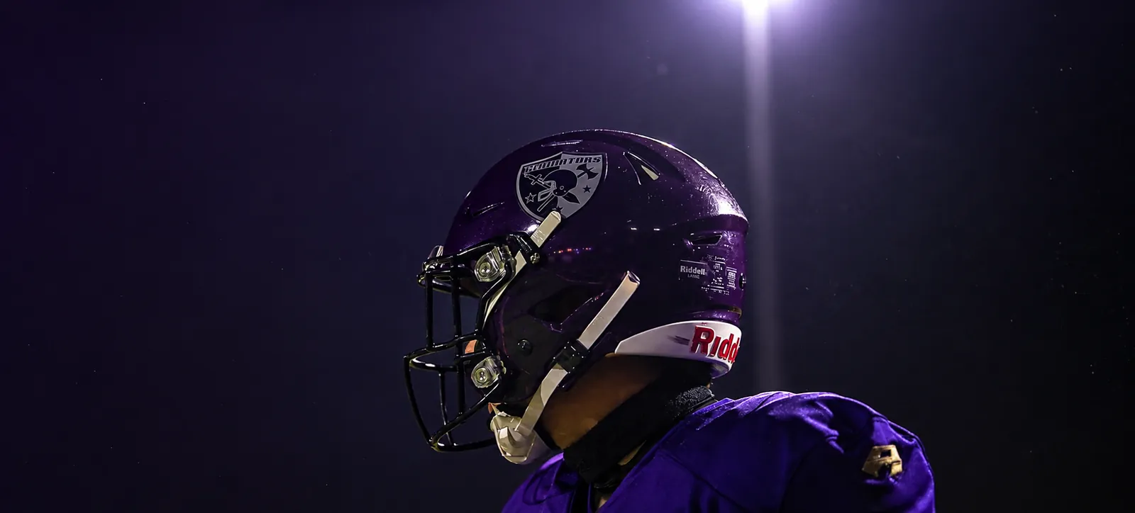 Gladiators Basel player in a purple helmet under the floodlights