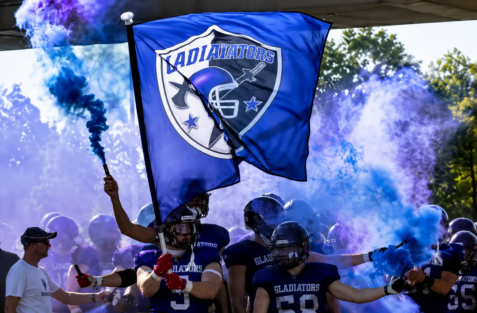 Gladiators players entering the field with flag and purple smoke
